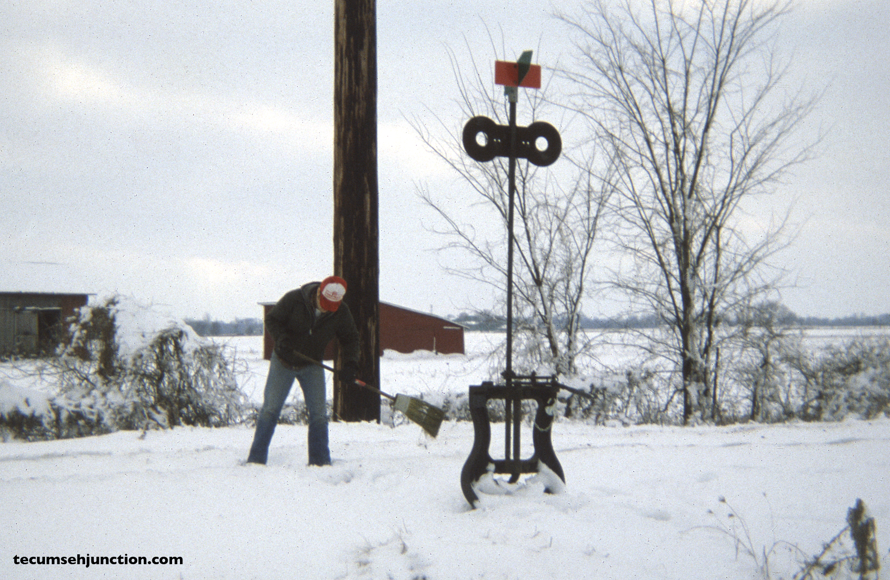 A crew member sweeps the switch at Grosvenor, Michigan. (12 December 1981)