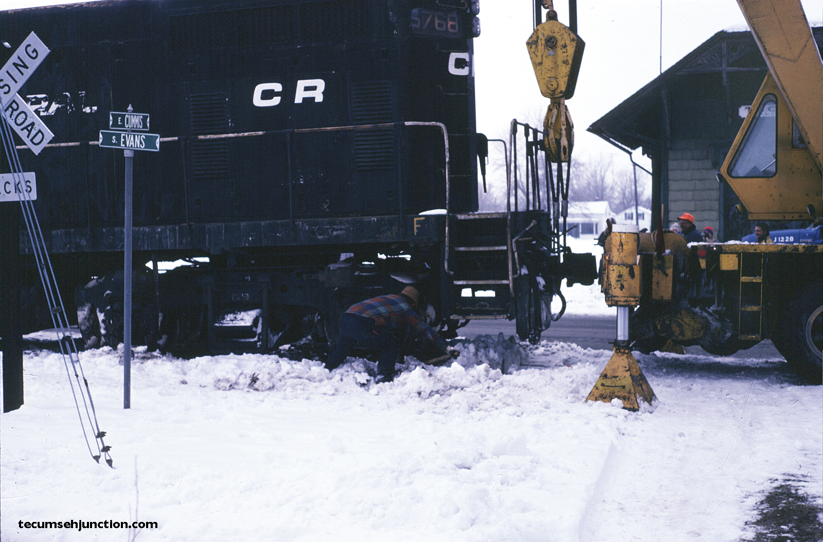 The "big lift"—a Conrail carman checks that the wheels are going to align with the rails.