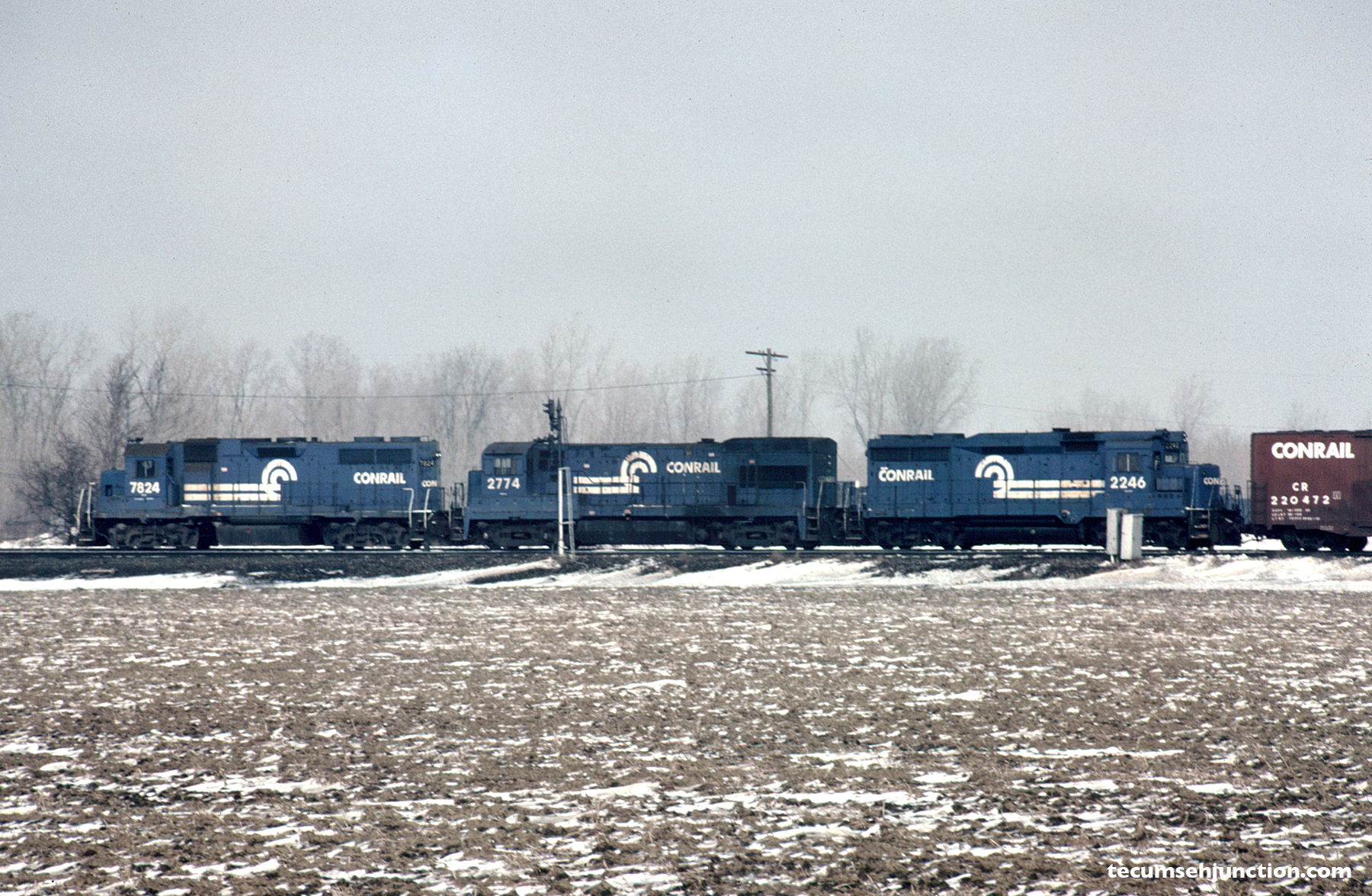 Conrail 7824, 2774 and 2246 lead a train near Stanley Tower on 10 March 1984.